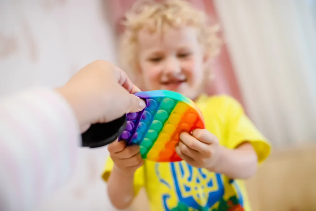 blond girl playing with pop it sensory toy a fash 2023 11 27 05 05 02 utc