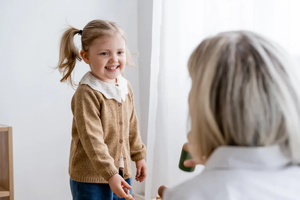 cheerful girl with ponytail smiling near blurred m 2023 11 27 05 31 06 utc