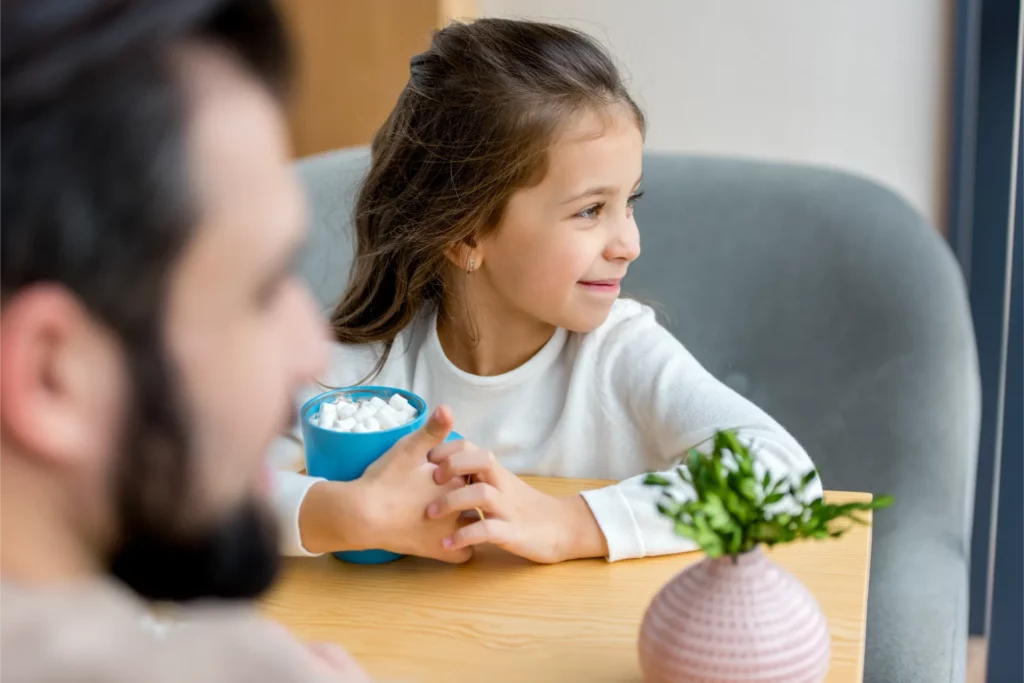 cropped image of daughter sitting with cup of caca 2023 11 27 05 33 13 utc