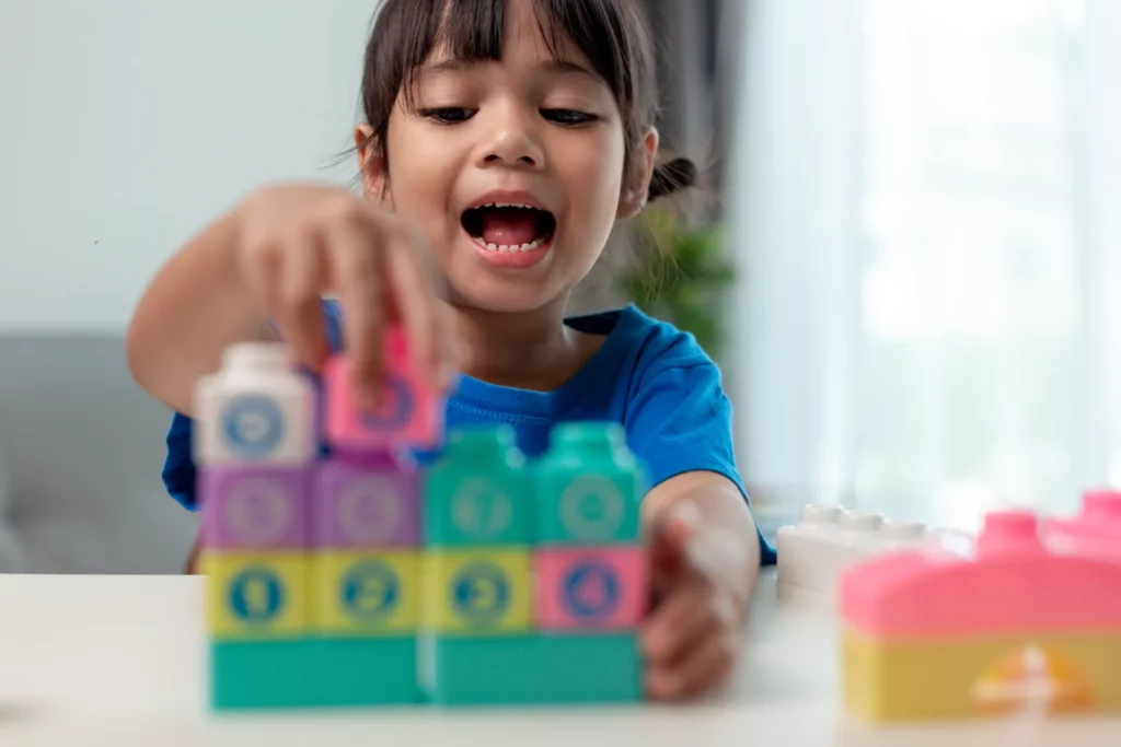 little child girl playing colorful blocks 2023 11 27 05 07 26 utc