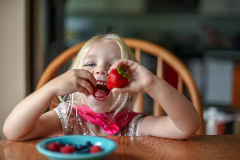 little girl eating strawberries at the kitchen tab 2023 11 27 05 15 21 utc